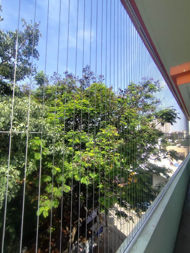 Invisible Grill — Balcony with Lush Tree View
